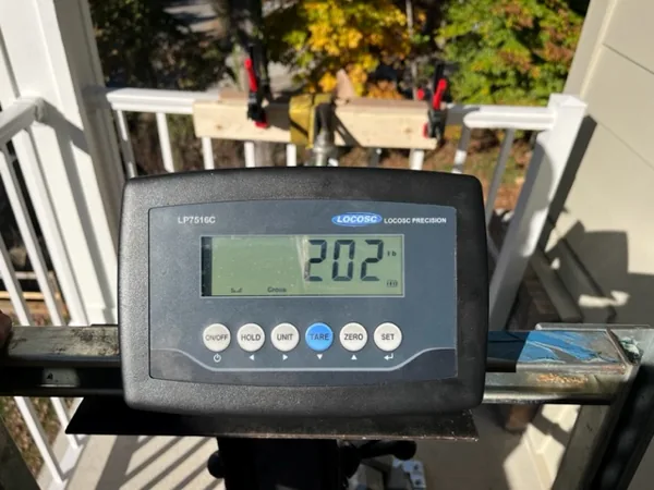 Digital load cell readout showing 202 lbs during anchor pull test